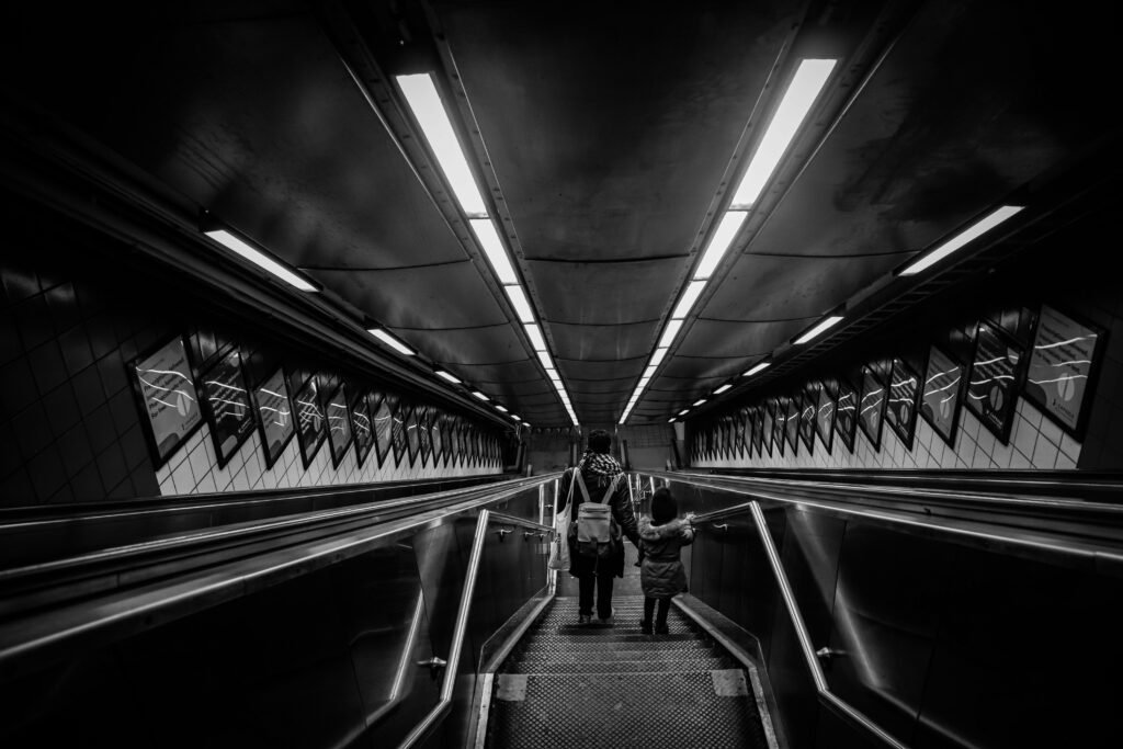 Photo by Gela delrose: https://www.pexels.com/photo/high-angle-shot-of-a-person-walking-down-a-stairway-with-a-child-5544864/
